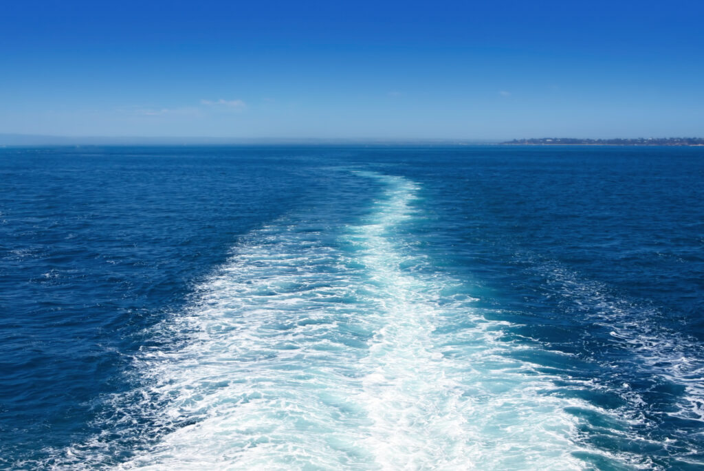 Boat wake in the sea, on a brilliant sunny day. Photo