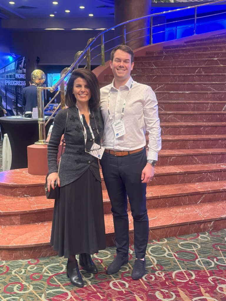 Two people standing together at a conference. Photo.